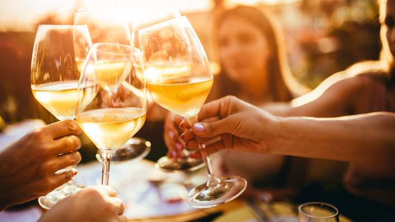 People clinking their wine glasses together