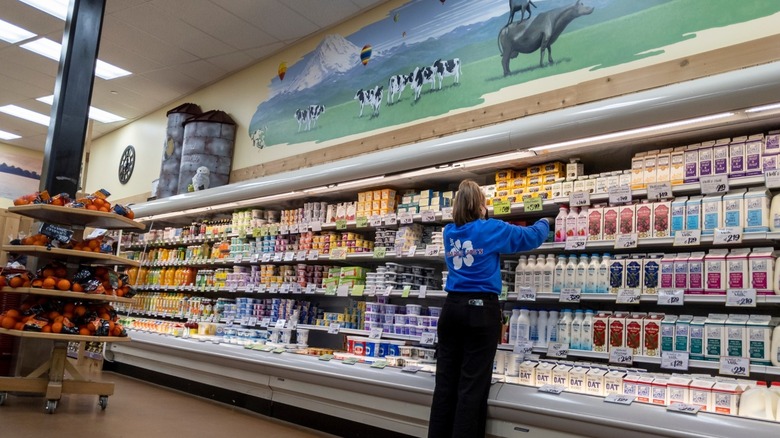 Trader Joe's worker stocking milk