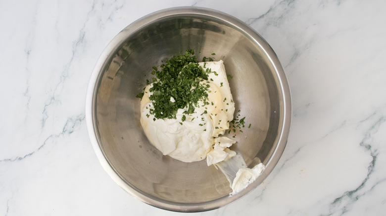 Mayonnaise, sour cream, and cilantro in bowl