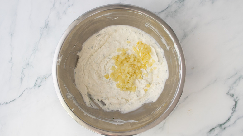 Creamy dip with sauteed onion and garlic in bowl