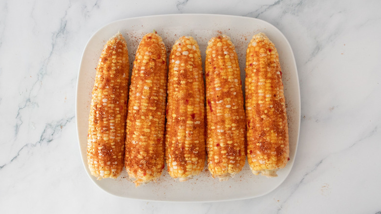 Seasoned corn on the cob on plate