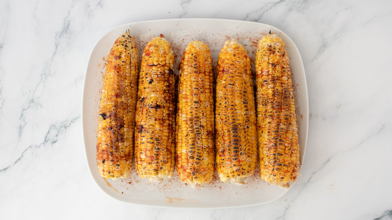 Charred corn on the cob on plate
