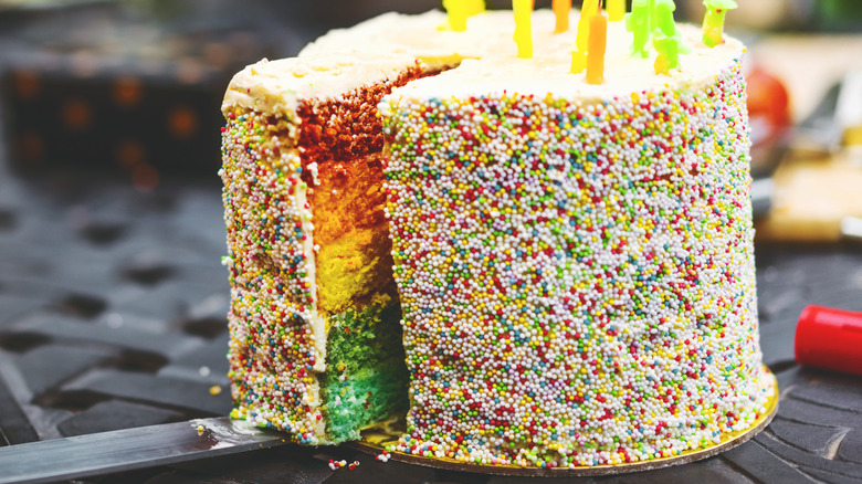 Cutting a sprinkle birthday cake