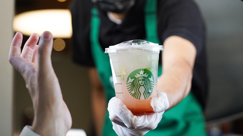 Starbucks barista with drink