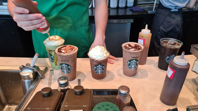 Starbucks barista with frappuccinos 