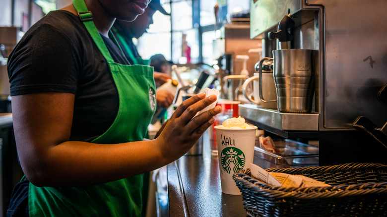 Starbucks barista making drinks