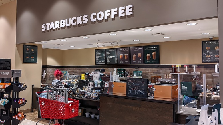 Starbucks location inside a Target with woman at counter