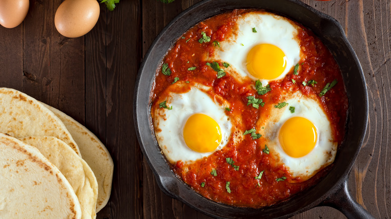 A pan of shakshuka and flat bread