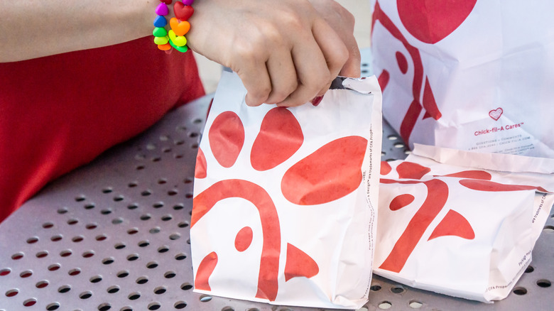 Chick-fil-A server handing out food orders