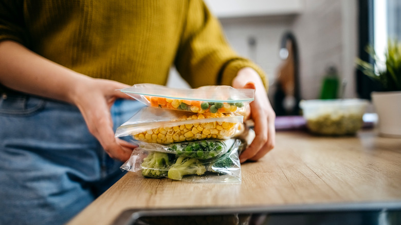 Person bagging up veggies