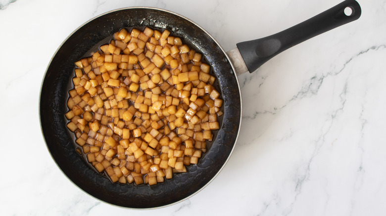cooked apples in a black frying pan