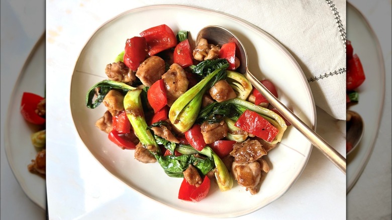 Spicy Ginger Chicken with Peppers and Bock choy on white plate