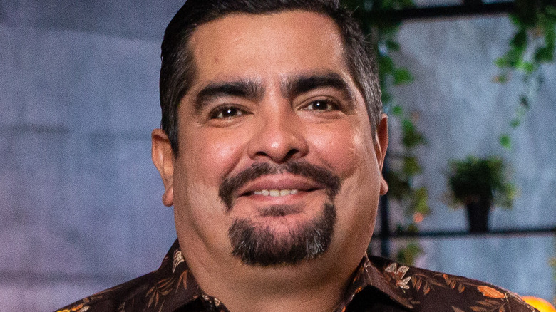 Aaron Sanchez smiling in floral shirt