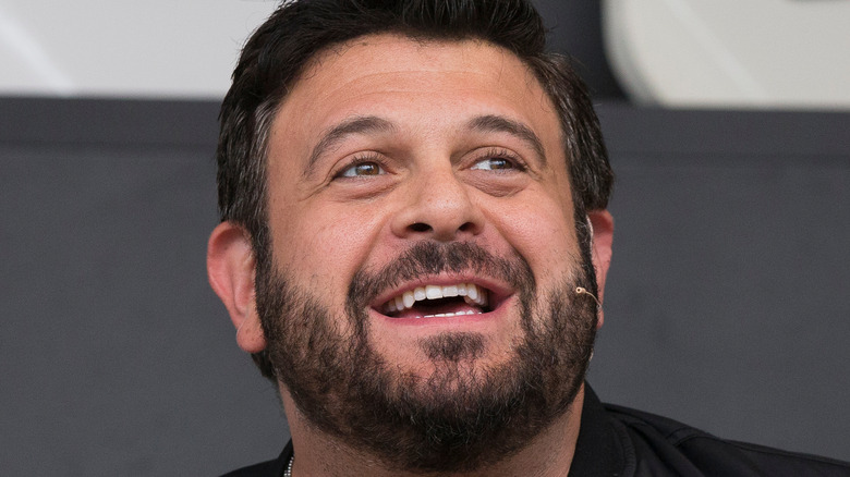 Adam Richman smiling at event 