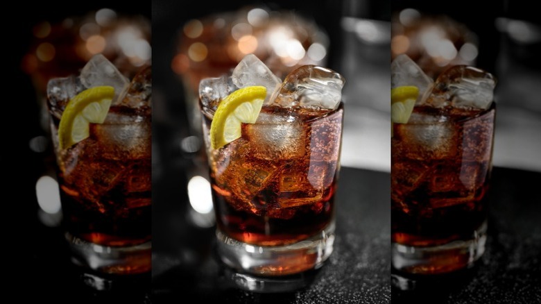 Bourbon and coke with a slice of lemon