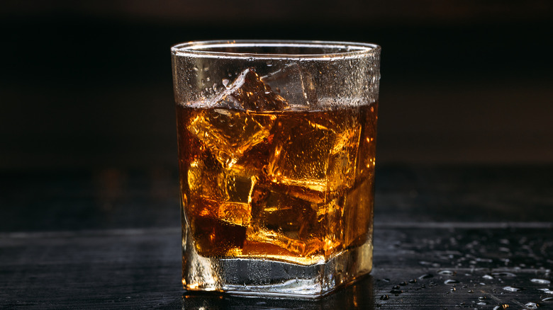 Whiskey and coke with ice on a bar