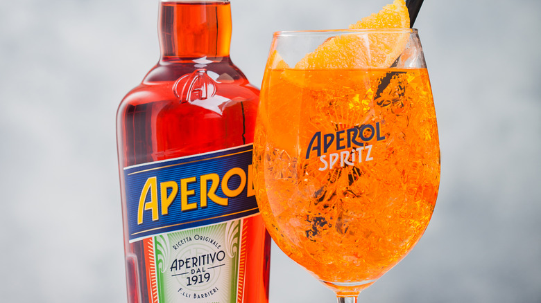 Bottle of Aperol with Aperol Spritz cocktail