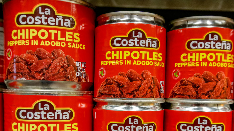 Cans of La Costena chipotles in adobo sauce stacked on each other