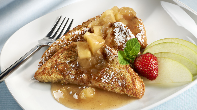 cooked french toast with syrup and fruit