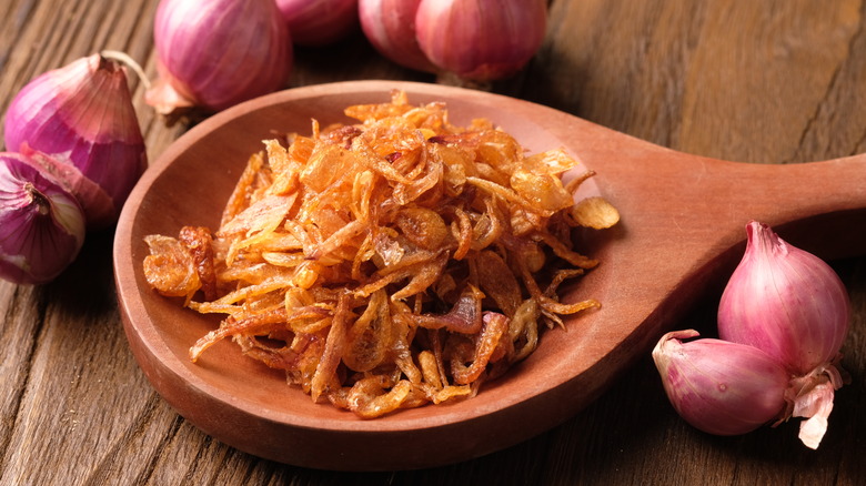 Wooden spoon with fried shallots