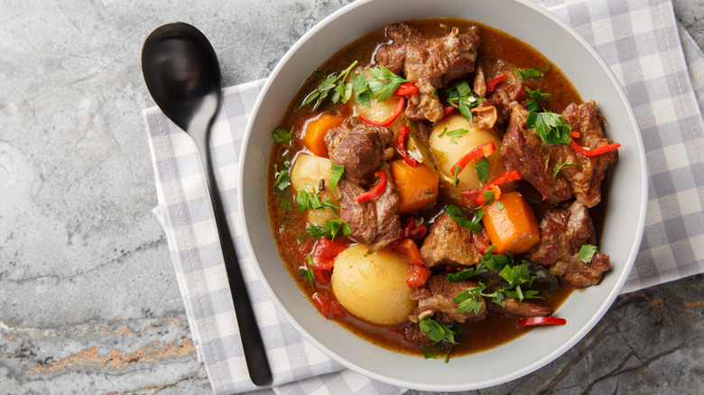 Beef stew in bowl with spoon
