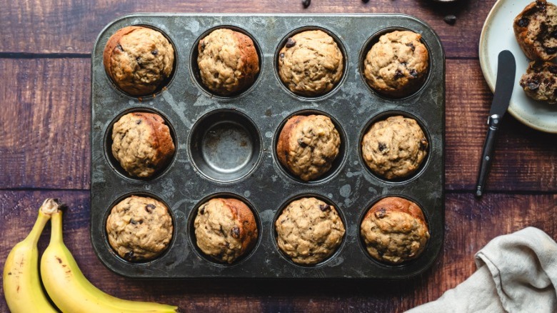 Tin with banana nut muffins that have been loosened cleanly from the edges