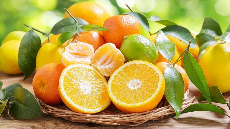 Oranges, lemons and limes on wooden table