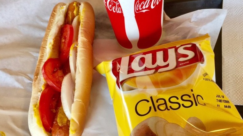 A Kasper's hot dog with Lay's chips and Coca Cola