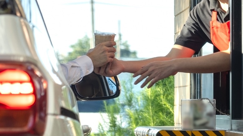 car receiving iced coffee at drive thru