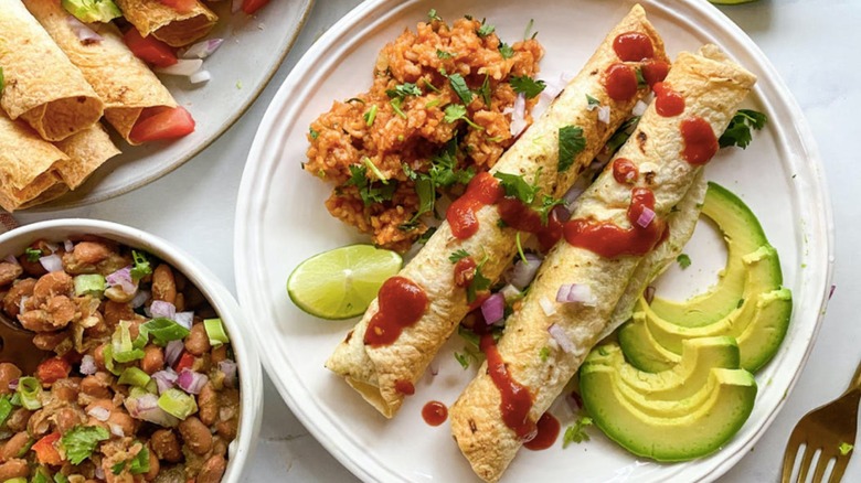 flautas on plate with rice