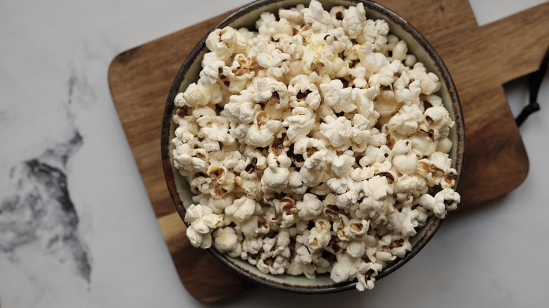 Bowl of popcorn on plank