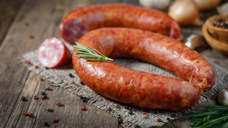 Sausage ring on burlap with rosemary sprig