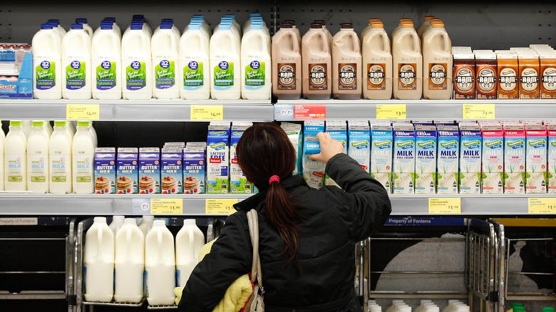 Woman grabbing milk at Aldi