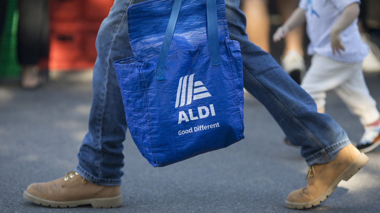 Person walking with Aldi bag