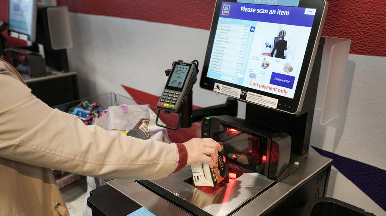 aldi shopper scanning items at self checkout
