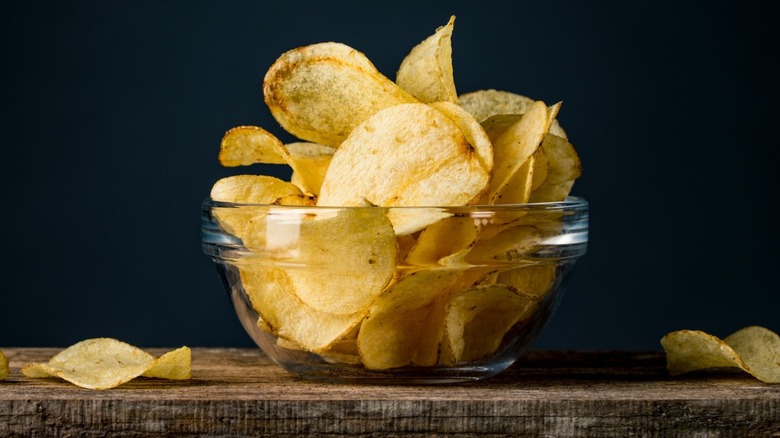 A clear bowl filled with potato chips