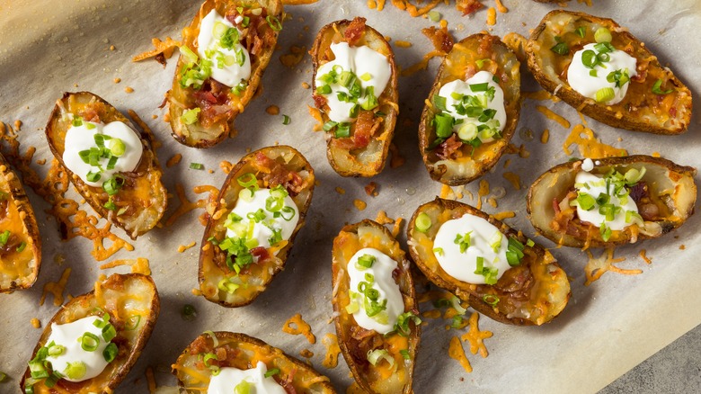 Loaded potato skins on parchment