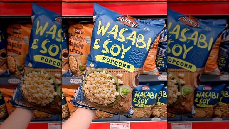 Hand holding bag of Aldi popcorn