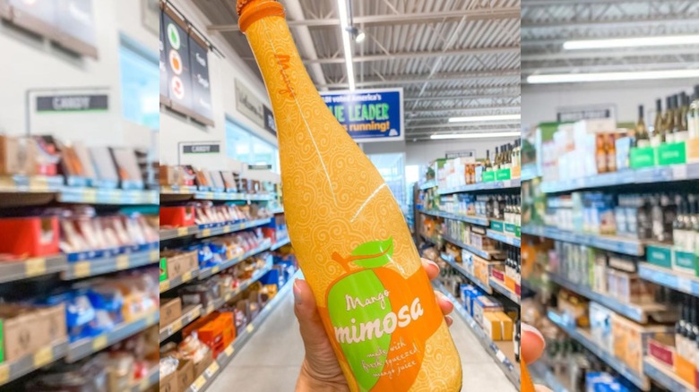 Orange bottle of fruity mimosa in Aldi shopping aisle