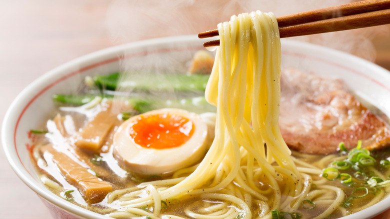 Chopsticks holding ramen