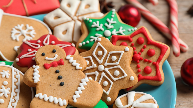 A plate of Christmas Cookies with candy canes on the side