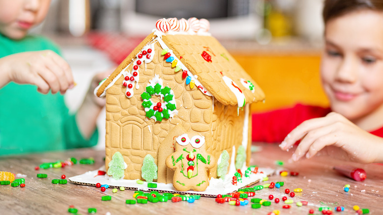 Kids building a gingerbread house