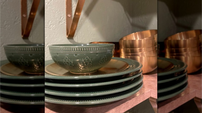 Four green plates from Aldi stacked with a bowl