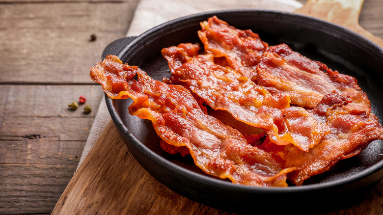 Crispy bacon sitting in a cast iron skillet