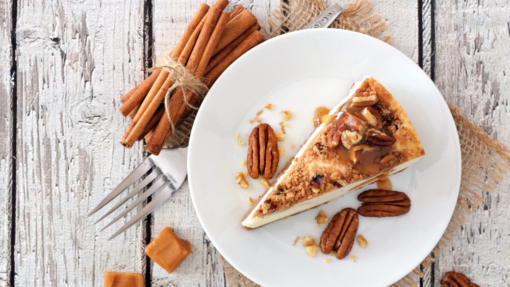 Slice of pecan and caramel topped cheesecake