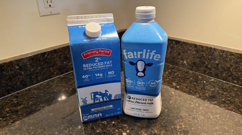 Two bottles of milk on the countertop
