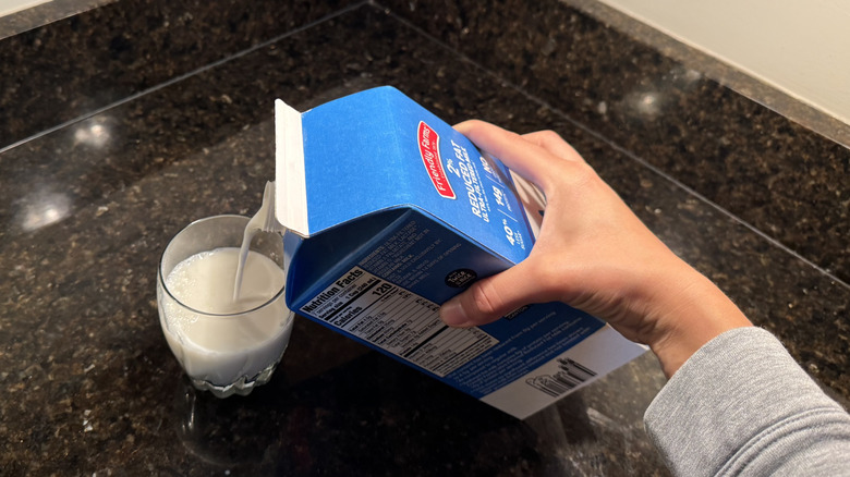 Pouring Friendly Farms milk into a glass
