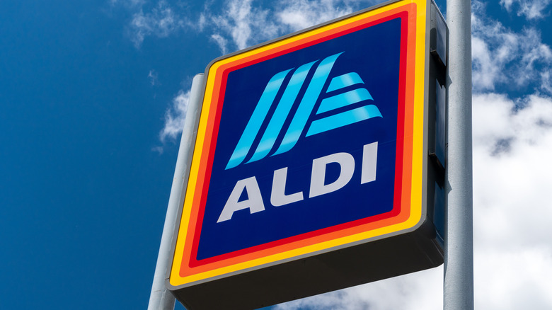 Colorful Aldi logo against blue sky background