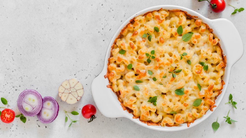 Baked pasta with herbs, red onion, garlic, and tomatoes