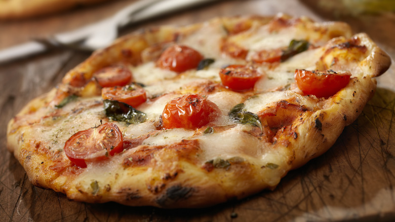 Margherita pizza on wooden board